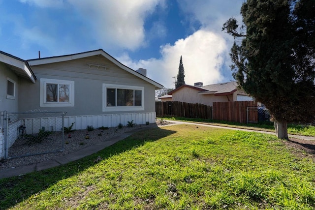 view of home's exterior with a yard