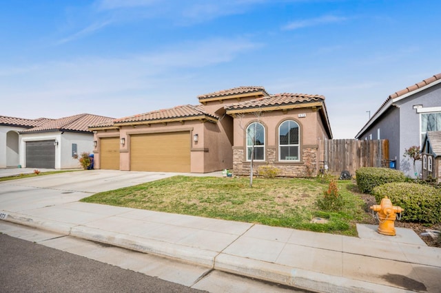 mediterranean / spanish house with a front lawn and a garage