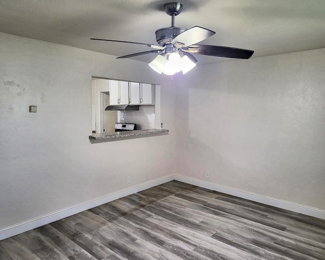 spare room featuring dark hardwood / wood-style floors and ceiling fan