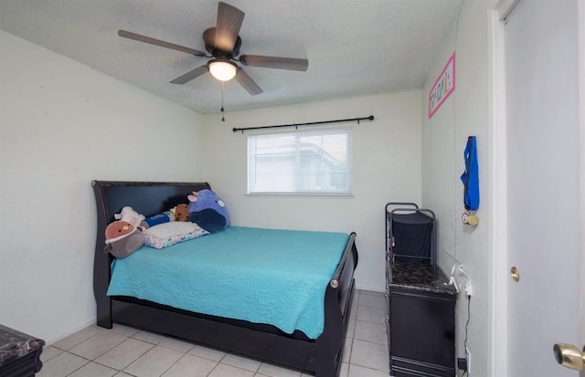 tiled bedroom featuring ceiling fan and a textured ceiling