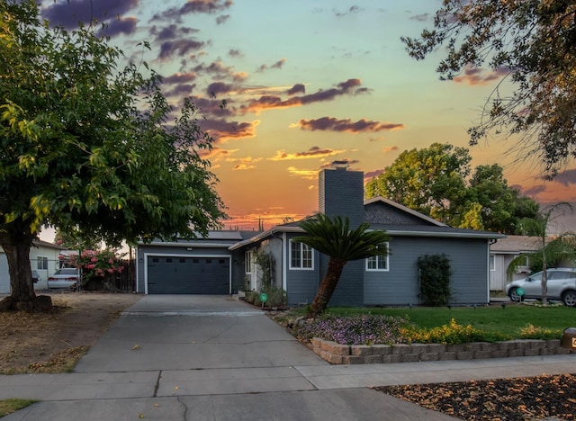 view of front of property featuring a garage and a yard