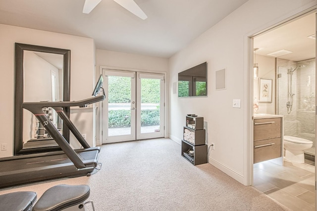 workout area featuring french doors, light carpet, and ceiling fan