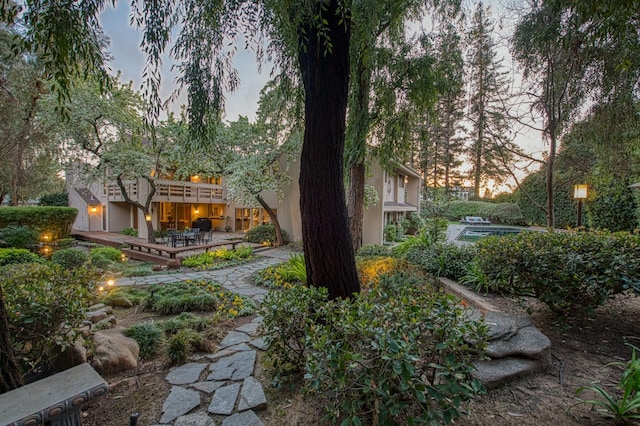 yard at dusk with a patio