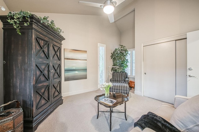 sitting room featuring ceiling fan, light carpet, and lofted ceiling