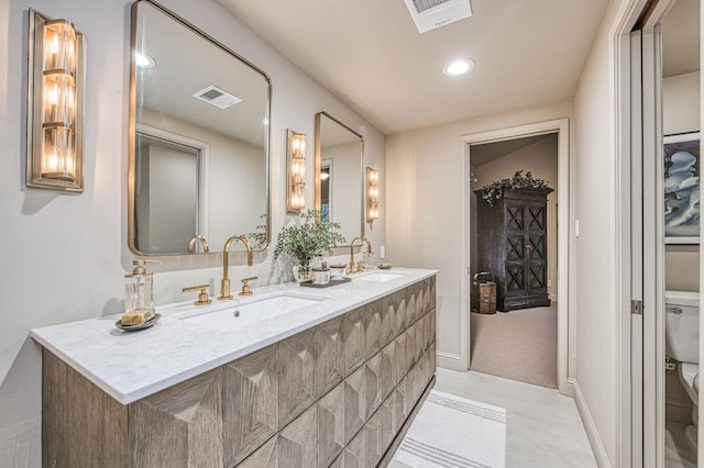 bathroom featuring toilet and vanity