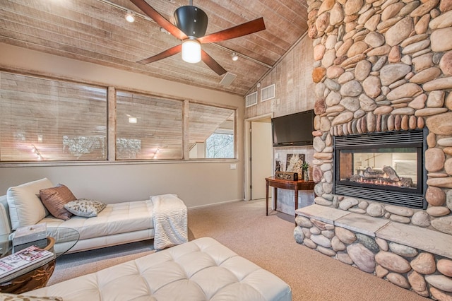 2352 W Loma Linda Ave, Fresno, CA 93711 - living room with vaulted ceiling, a ceiling fan, a stone fireplace, carpet floors, and visible vents