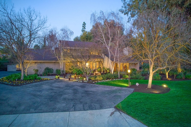 mediterranean / spanish-style house with a front lawn