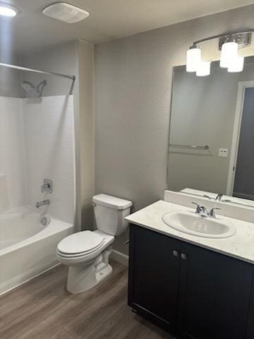 full bathroom with toilet, vanity, shower / bathtub combination, and hardwood / wood-style floors