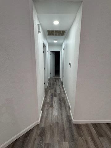 corridor with dark hardwood / wood-style floors