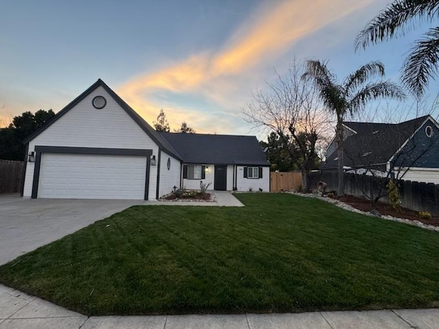 view of front facade featuring a garage and a yard