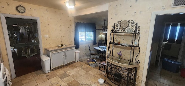 bathroom featuring wallpapered walls and visible vents