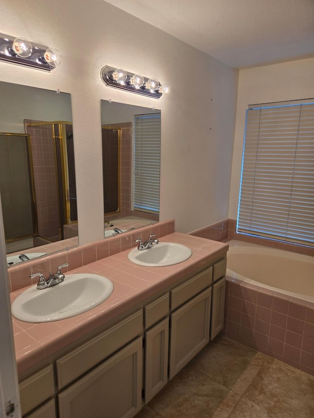 bathroom featuring tile patterned floors, independent shower and bath, and vanity
