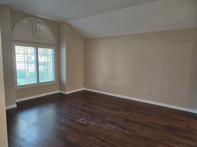 bonus room with vaulted ceiling and dark wood-type flooring