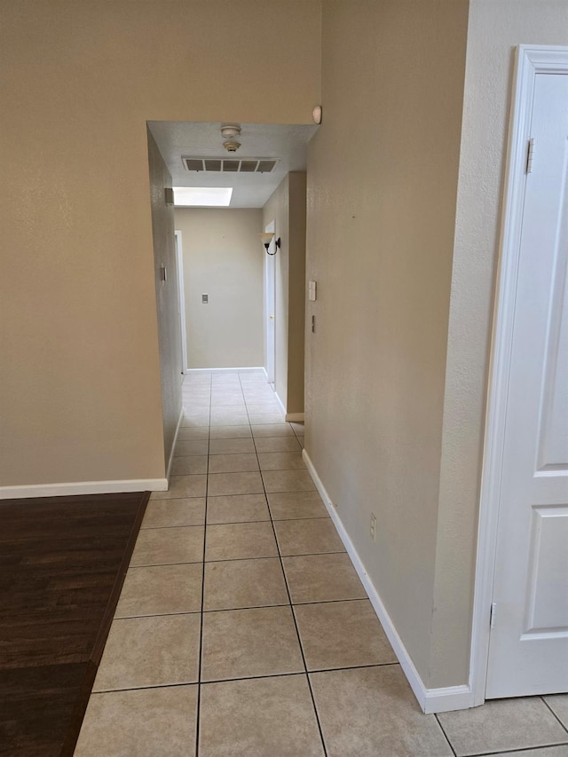 hall featuring light tile patterned floors