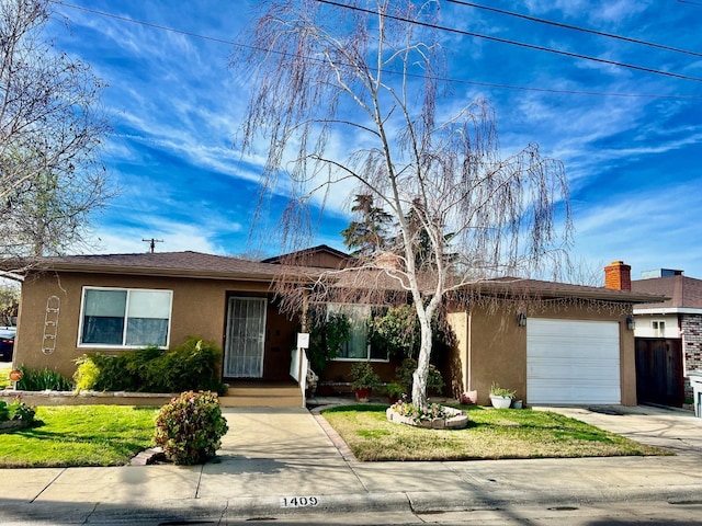 single story home with a front yard and a garage