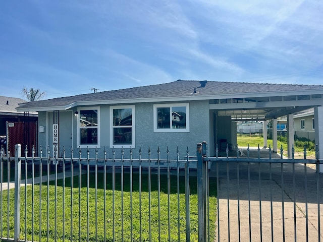 exterior space featuring a fenced front yard, a shingled roof, driveway, a carport, and a front yard