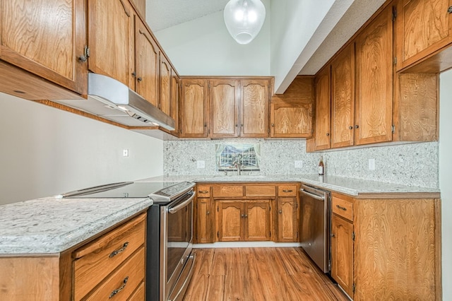 kitchen featuring sink, decorative backsplash, stainless steel appliances, and light hardwood / wood-style floors