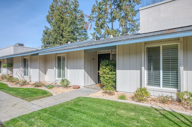 view of exterior entry featuring a yard