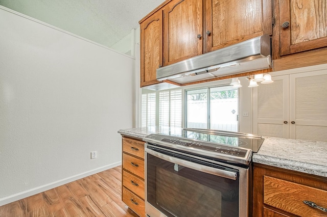 kitchen with electric stove and light hardwood / wood-style flooring