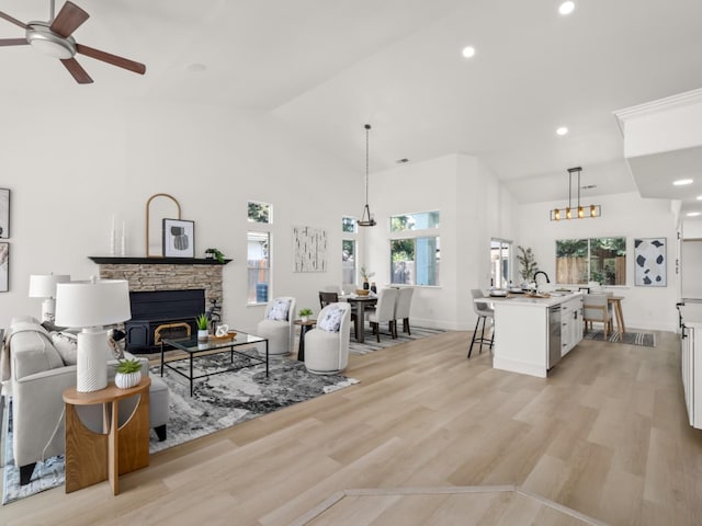 living room featuring recessed lighting, a ceiling fan, light wood-type flooring, and high vaulted ceiling