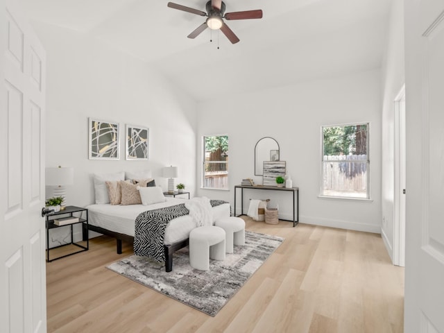 bedroom featuring light hardwood / wood-style flooring, ceiling fan, and vaulted ceiling