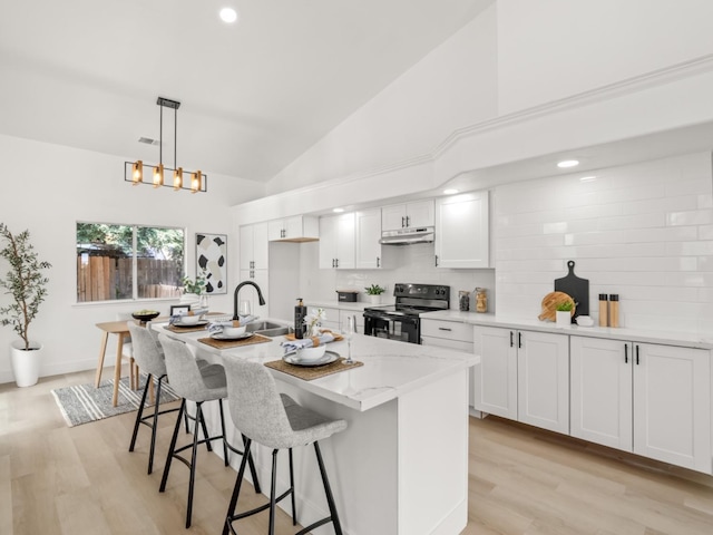 kitchen with a center island with sink, decorative light fixtures, white cabinets, light stone countertops, and black range with electric stovetop