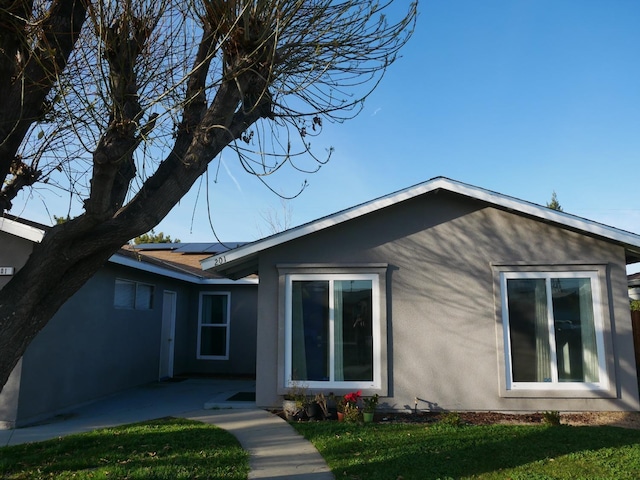 view of home's exterior featuring a lawn and a patio area