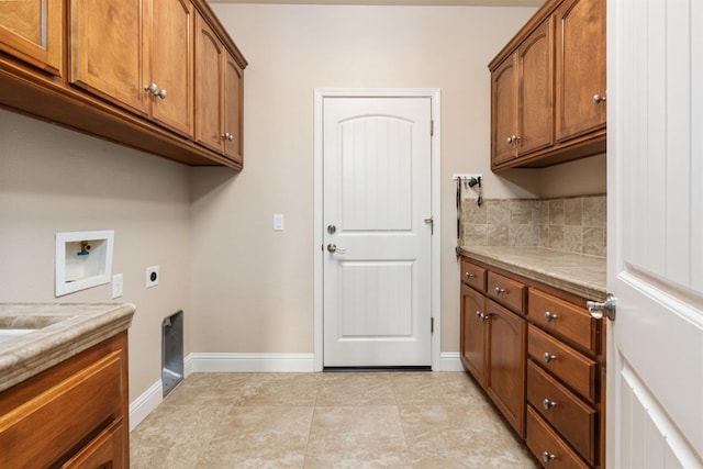 laundry area with cabinets, hookup for an electric dryer, washer hookup, and light tile patterned floors