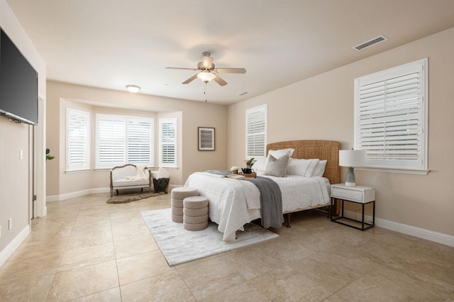 tiled bedroom featuring ceiling fan