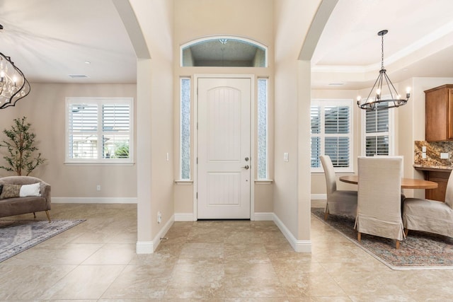 foyer entrance featuring a notable chandelier