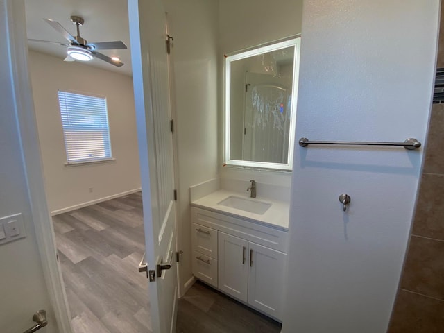 bathroom featuring hardwood / wood-style flooring, ceiling fan, and vanity