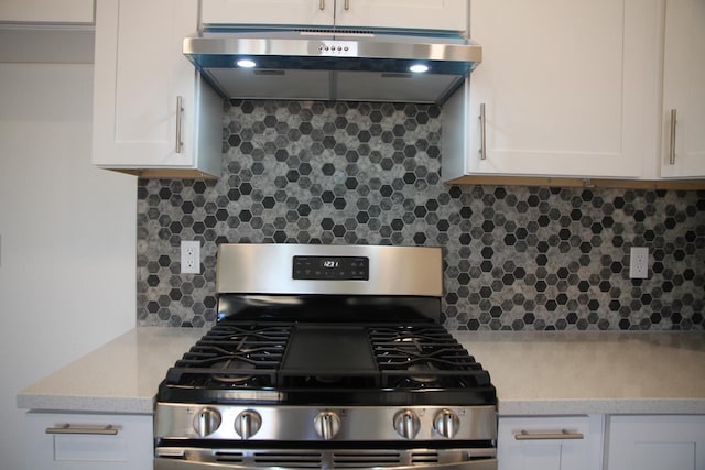 kitchen featuring white cabinetry, extractor fan, backsplash, and stainless steel gas stove