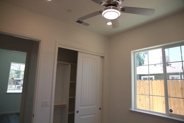 unfurnished bedroom with a closet and ceiling fan