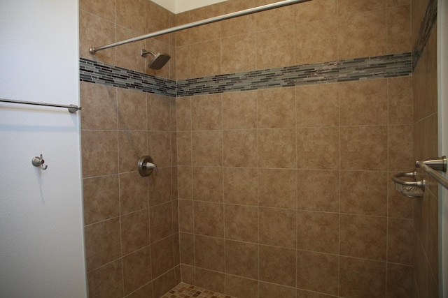 bathroom with a tile shower