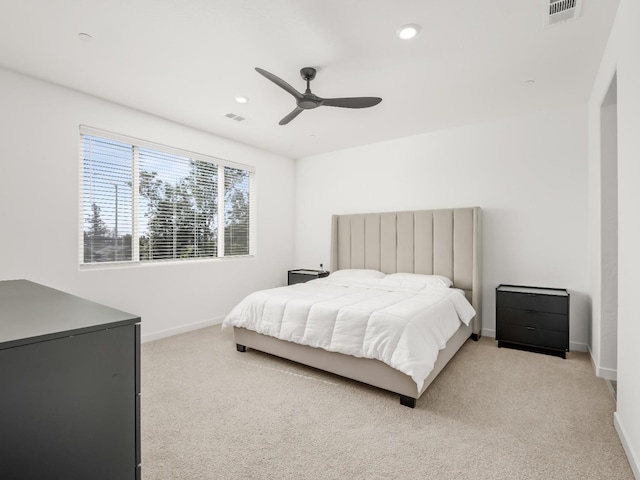 bedroom featuring light carpet and ceiling fan