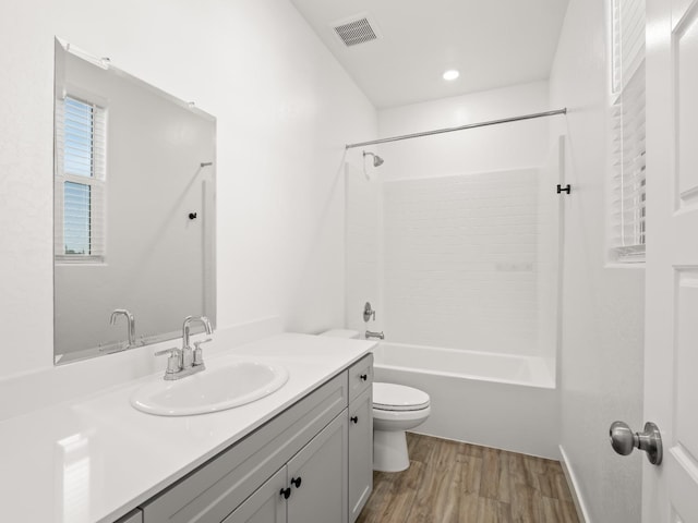 full bathroom featuring toilet, vanity, shower / washtub combination, and wood-type flooring