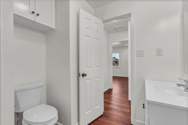 bathroom featuring hardwood / wood-style flooring, toilet, and vanity