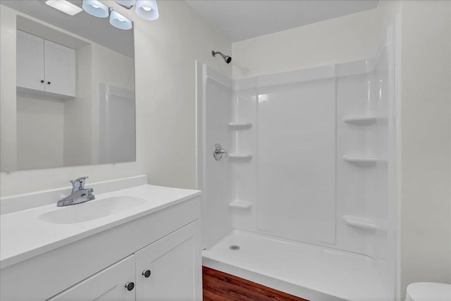 bathroom featuring a shower and vanity