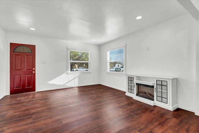 unfurnished living room featuring dark hardwood / wood-style floors