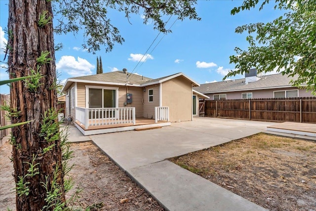 back of house with a deck, cooling unit, and a patio area