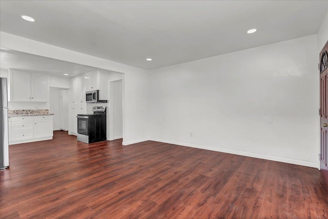 unfurnished living room with dark wood-type flooring