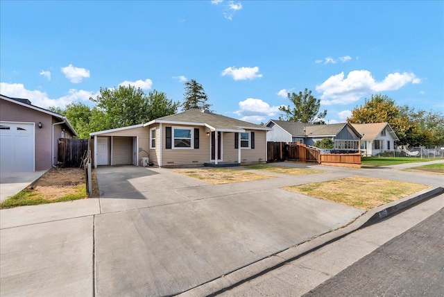 ranch-style house featuring a garage and a carport