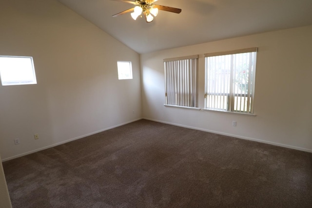 carpeted spare room featuring vaulted ceiling and ceiling fan