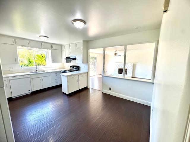 kitchen with range with electric stovetop, light countertops, white cabinetry, a sink, and dishwasher