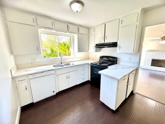 kitchen featuring electric range, dark hardwood / wood-style flooring, sink, dishwasher, and white cabinets