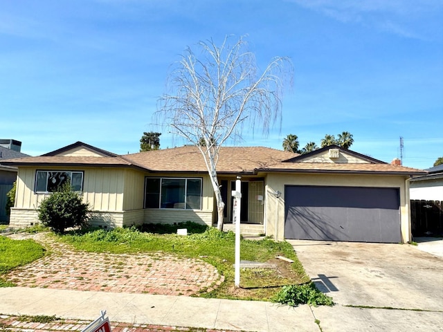 single story home featuring concrete driveway and an attached garage