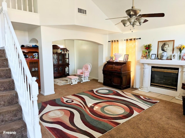 carpeted living room featuring high vaulted ceiling and ceiling fan