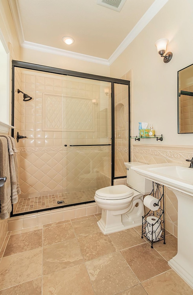 bathroom with visible vents, a shower stall, toilet, and crown molding