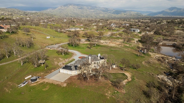 birds eye view of property with a rural view and a water and mountain view