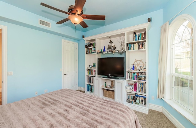 bedroom with baseboards, visible vents, ceiling fan, and carpet flooring